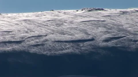 Wind blowing snow over hillside in winter Video stock 11365550