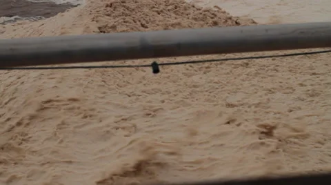 The wind is blowing so hard the foam spray has washed up during a hurricane. Stock Footage 55215334