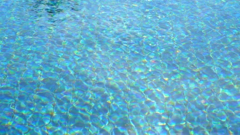 Wind blowing water surface of a blue clear outdoor swimming pool Stock Footage 107774833