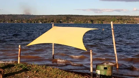 Wind Blowing a yellow make shift shelter at Parque dos Garcas Stock Footage 113421914