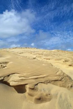 Wind-blown sand and clouds 스톡 사진