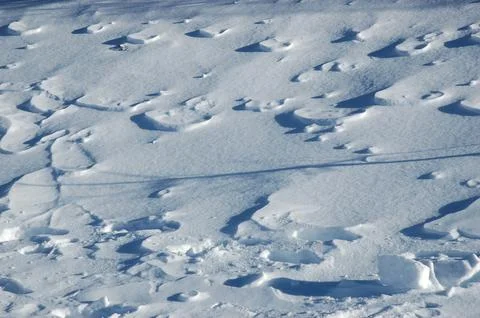 Wind blown snow patterns on a winter slope Stock Photos