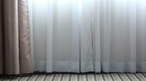 The wind blows and light shines through white curtains Stock Footage 51562559