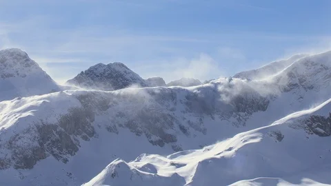 The wind blows away snow from mountains Stock Footage 101898314