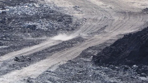 Wind blows dust on the clay road near the plant close-up Stock Footage 105728236