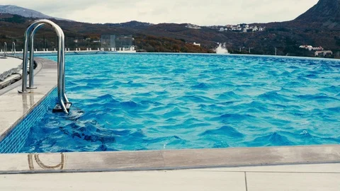 The wind blows over the surface of the pool Stock Footage 99076531