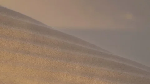 Wind blows sand in desert dunes close up with focus pull Stock Footage 103673365
