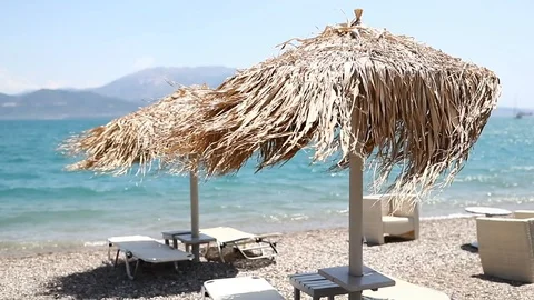 Wind blows thatch beach umbrella, slow motion . Stock Footage 118576864