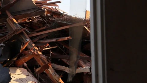 Wind blows through the doorway to trash Stock Footage 94695892