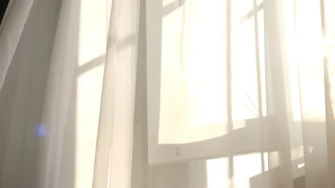 Wind blows through the open window in the room. Waving white tulle near the Stock Footage 139271660