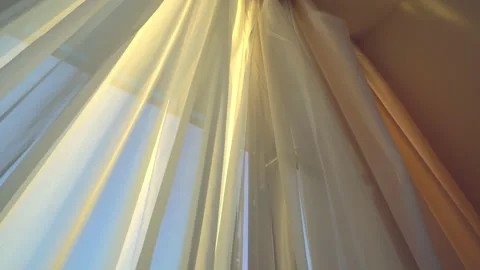 Wind blows through open window in room. Swinging curtains by window in windows Stock Footage 171588990
