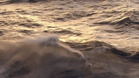 Wind blows the top off of large waves on the Caribbean Sea at sunset. Stock Footage 313503779