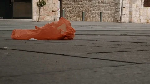 The wind carries a garbage bag along the street of Jerusalem 스톡 동영상 76120140
