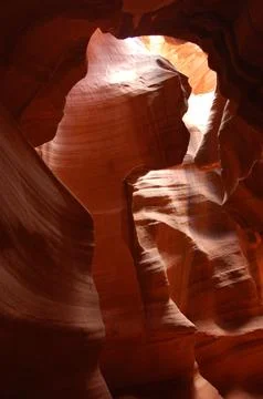 Wind cavern with light illuminating dust Stock Photos
