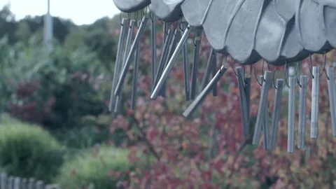 Wind chime being harshly struck repeatedly by a child Stock Footage 219105775