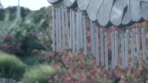 Wind chime being struck by a child Stock Footage 219106069