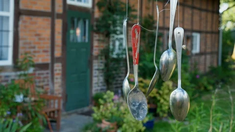 Wind chime made from old spoons in a garden of a farm Video stock 92212269