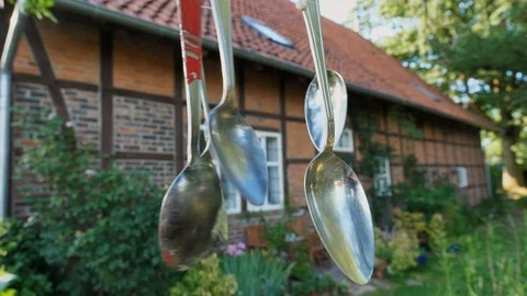 Wind chime made from old spoons in a garden of a farm Stock Footage 92212295