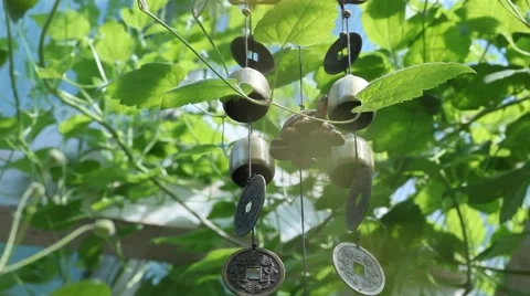 Wind chime tube mobile, blue sky background Stock Footage