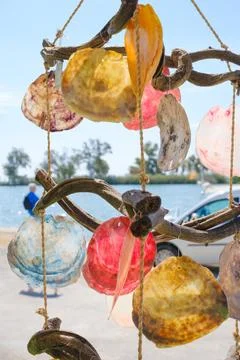 Wind chimes made with colored shells and pieces of wood. Stock Photos