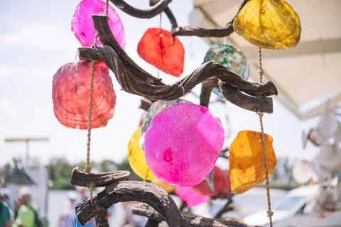 Wind chimes made with colored shells and pieces of wood. Stock Photos