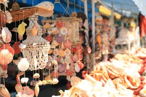 Wind chimes made of sea shells in outdoor souvenir shop. Space for text Stock Photos