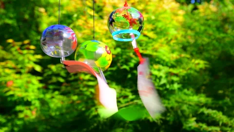 The Wind Chimes Reflecting in the Red Maple Leaves Vídeos de archivo 330743555