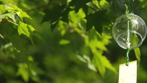 Wind chimes swaying with the wind, small and fresh wind chimes in the sunlight Stock Footage 273481708