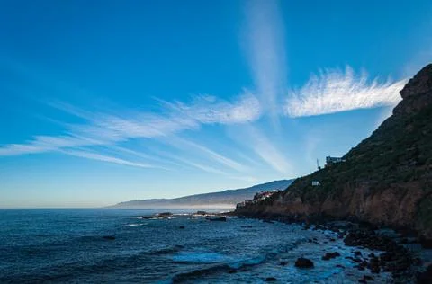 Wind clouds over the calm coast of Tenerife Stock Photos