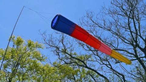 Wind cone fluttering in the breeze. Blue-red-yellow windsock. Stock Footage 85476971