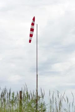 Wind cone.Wind strength indicator in the form of a striped cone. Stock Photos