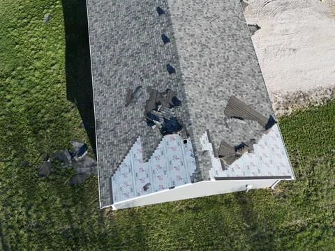 Wind damage roofing shingles Stock Photos