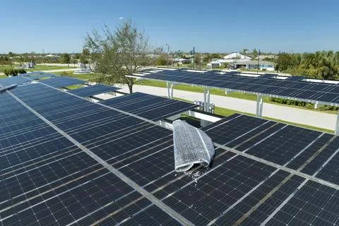 Wind damage to solar panels installed over parking lot canopy shade for par.. Stock Photos
