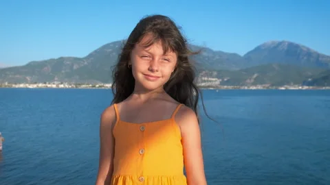 Wind develops child hair on piers. 스톡 동영상 249703717
