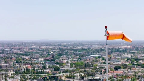 Wind direction indicator on background of city landscape. 動画素材 76079092