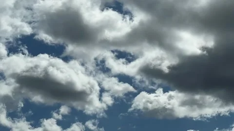 Wind-driven clouds racing across blue sky in fast timelapse Stock Footage 343066836