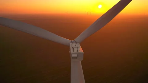 Wind driven generator with large blades rotates at sunset Stock Footage 166034693