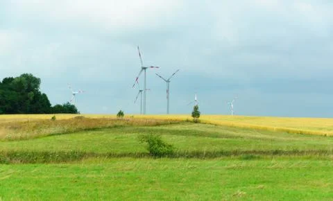Wind-driven generator in the middle of a field Stock Photos