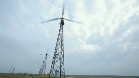 Wind driven generators, turbines over blue sky Stock Footage 50556698