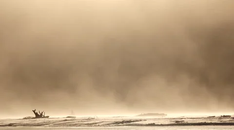 Wind Driven Sandstorm Blowing over Desolate Flats with Glow 4K Stock Footage 60703488