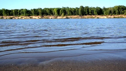 The wind drives the waves on the river, lake, waves on a sandy beach Stock Footage 93256579