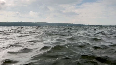 The wind drives the waves on the river, lake Stock Footage 94860440