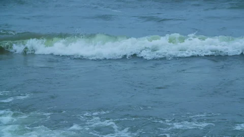 The wind drives the waves towards the shore in slow motion Stock Footage 289736163