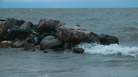 The wind drives the waves towards the shore and smashes them against the rocks Stock Footage 289808698