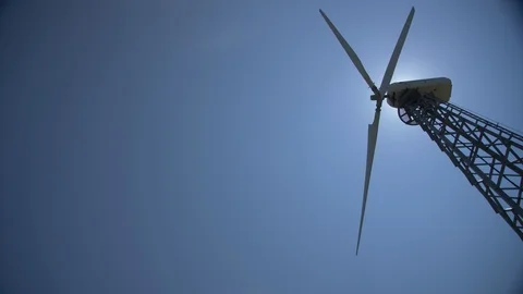 Wind electro turbine while working against the sky and the sun Stock Footage 109486327