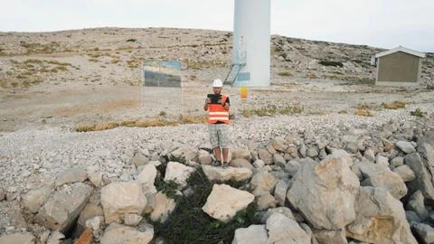 Wind energy engineer testing the function of windmill through his tablet Foto stock