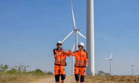 Wind energy technicians walking and coordinating maintenance tasks Stock Photos