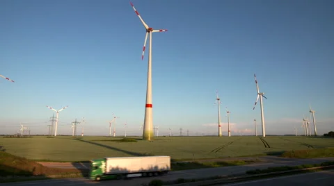 Wind Energy / Wind Power / Wind Turbine next to a Highway. Stock Footage 64368790