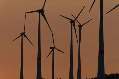 Wind engines in rural scene with setting sun Stock Photos