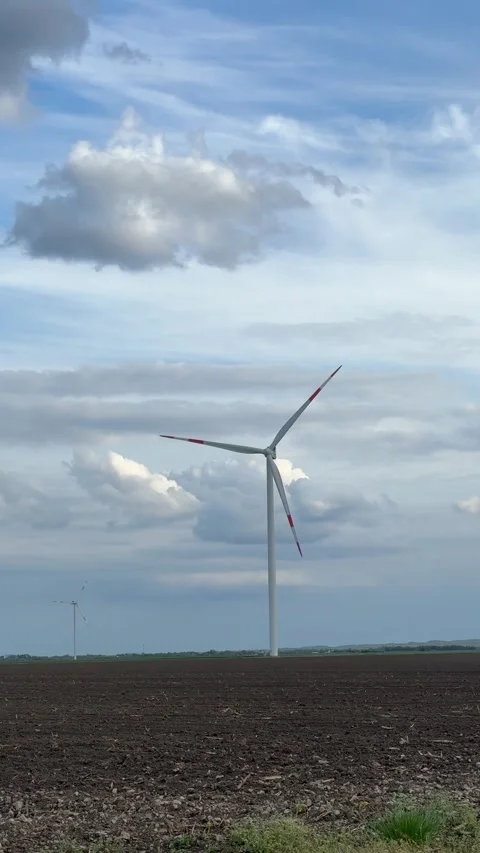 Wind Farm Across Agricultural Fields Under Dramatic Cloudy Sky Stock Footage 335811202